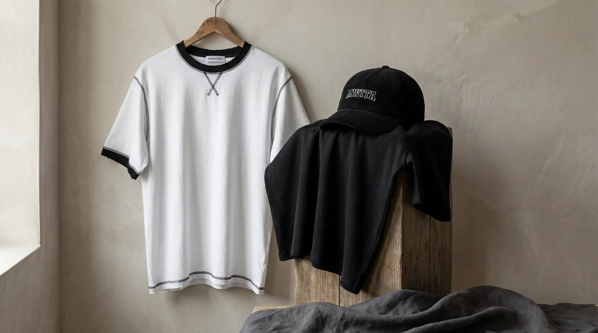 Refined editorial image of soft cotton garments and folded fabric arranged to express comfort, balance, and everyday ease.