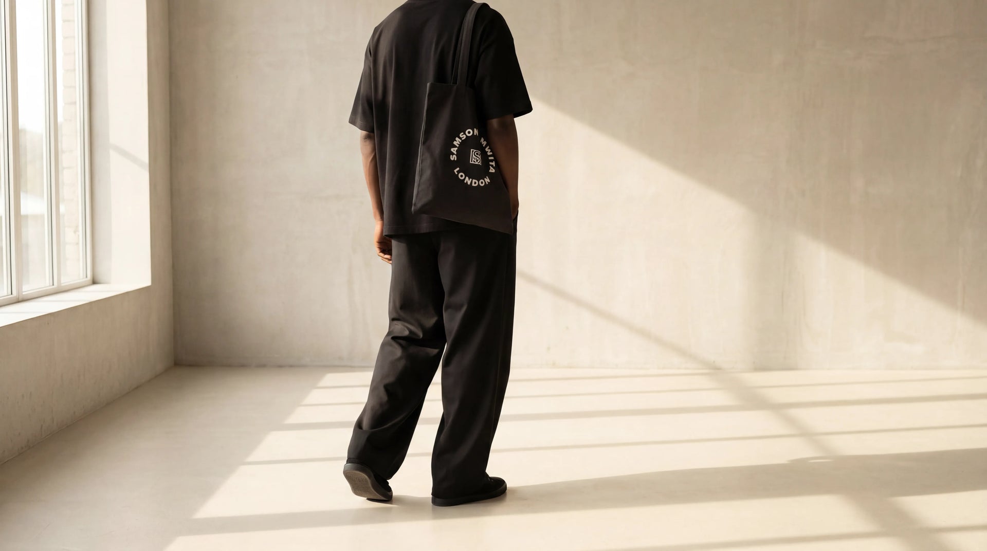 Minimal wardrobe image of a few carefully arranged garments and one accessory expressing consistency, ease, and everyday dressing.