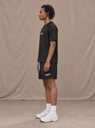 Model wearing the SM Motion Mesh T-shirt and SM Motion Mesh Shorts in black, side profile.