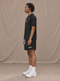 Model wearing the SM Motion Mesh T-shirt and SM Motion Mesh Shorts in black, side profile.