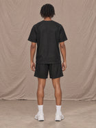 Model wearing the SM Motion Mesh T-shirt and SM Motion Mesh Shorts in black, rear view.