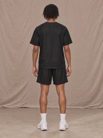 Model wearing the SM Motion Mesh T-shirt and SM Motion Mesh Shorts in black, rear view.