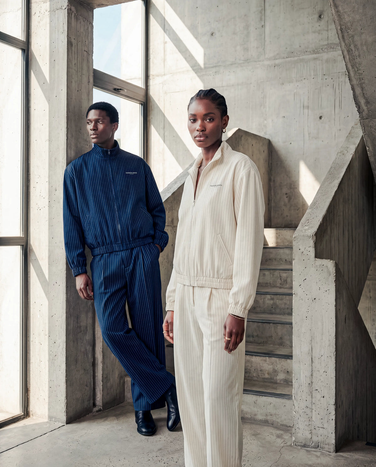 Hero - Two models wearing the navy and oat SM Axis line with the woman in the front.