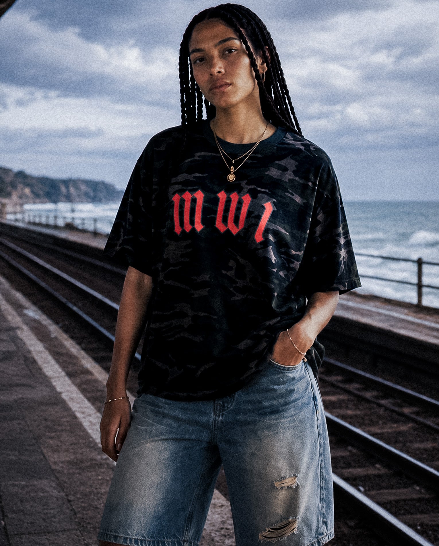 Model wearing SM Script camo t-shirt and Heritage denim shorts