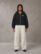 Model wearing SM Sig. Full-Zip Boxy Hoodie in Midnight Black, front view.