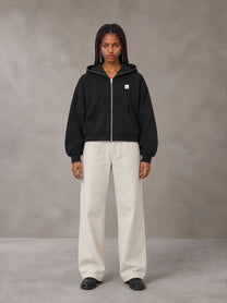 Model wearing SM Sig. Full-Zip Boxy Hoodie in Midnight Black, front view.