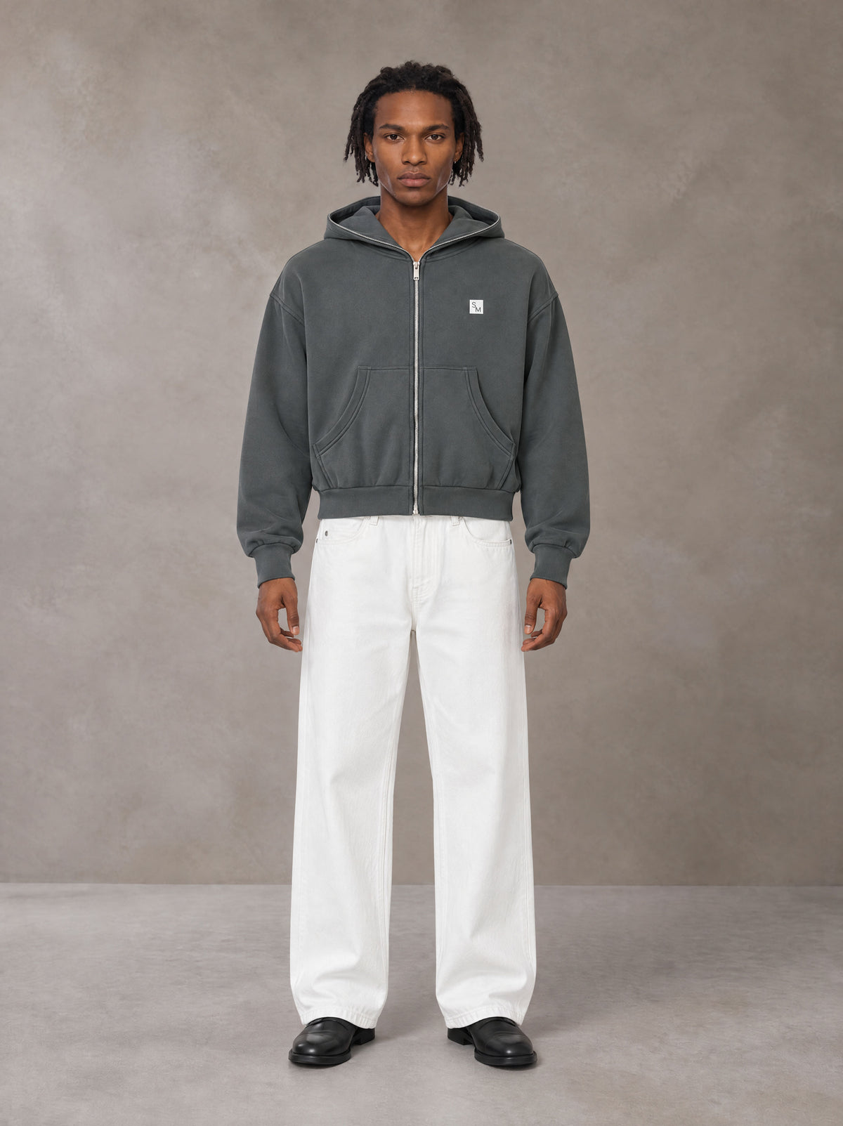 Model wearing SM Sig. Full-Zip Boxy Hoodie in Deep Charcoal, front view.