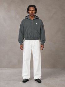 Model wearing SM Sig. Full-Zip Boxy Hoodie in Deep Charcoal, front view.