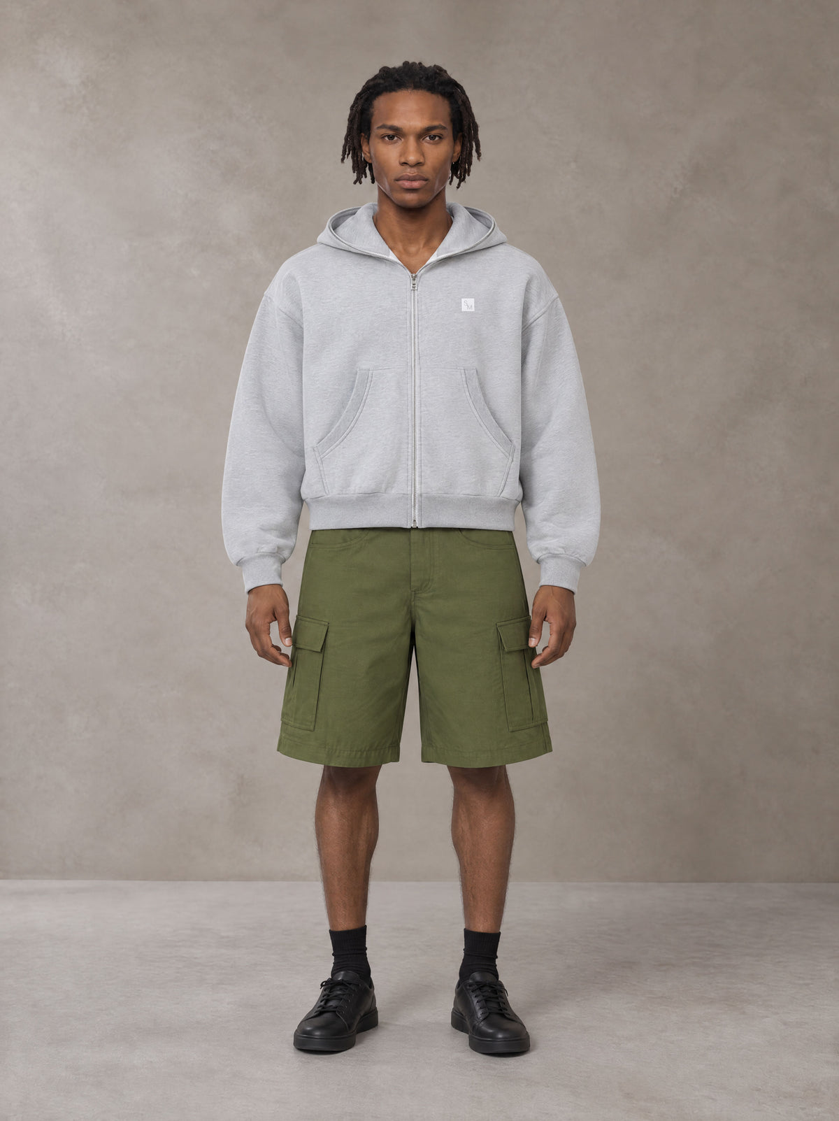 Model wearing SM Sig. Full-Zip Boxy Hoodie in Floral Grey, front view.