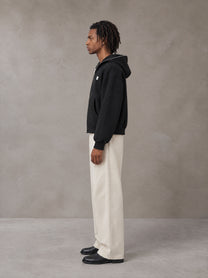 Model wearing SM Sig. Full-Zip Boxy Hoodie in Midnight Black, side view.