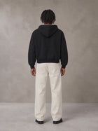 Model wearing SM Sig. Full-Zip Boxy Hoodie in Midnight Black, rear view.