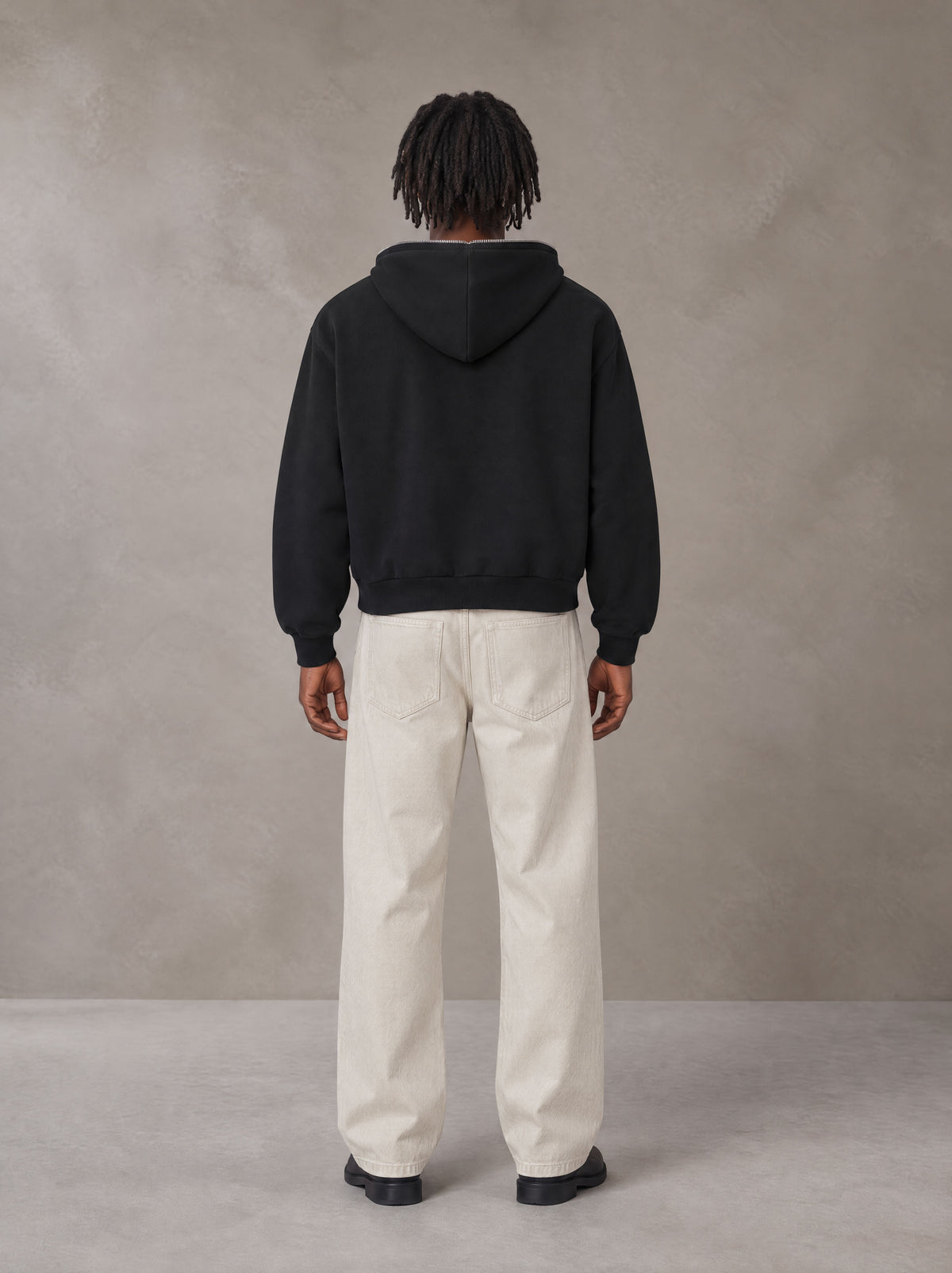 Model wearing SM Sig. Full-Zip Boxy Hoodie in Midnight Black, rear view.