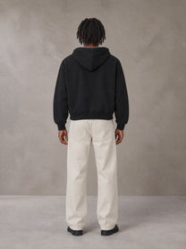 Model wearing SM Sig. Full-Zip Boxy Hoodie in Midnight Black, rear view.