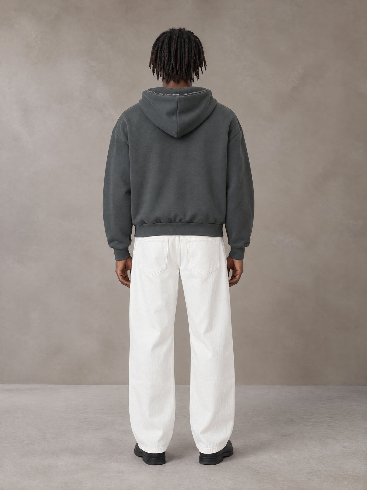 Model wearing SM Sig. Full-Zip Boxy Hoodie in Deep Charcoal, rear view.