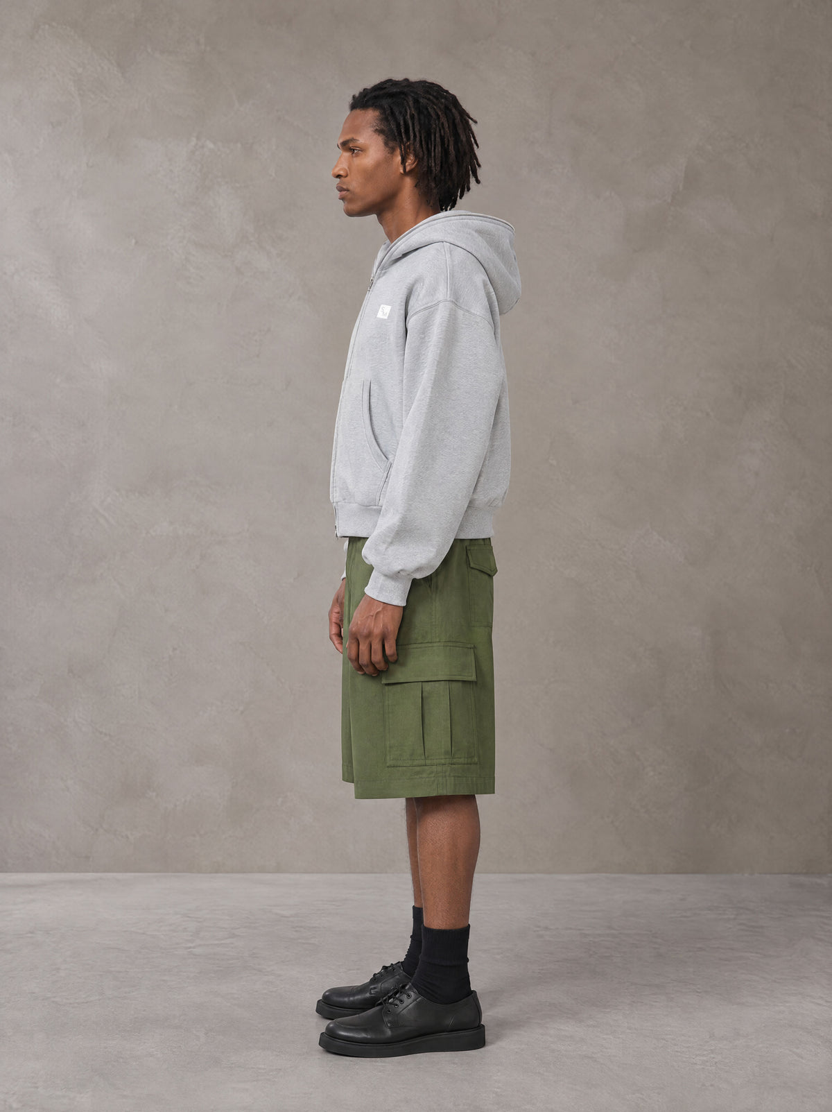 Model wearing SM Sig. Full-Zip Boxy Hoodie in Floral Grey, side view.