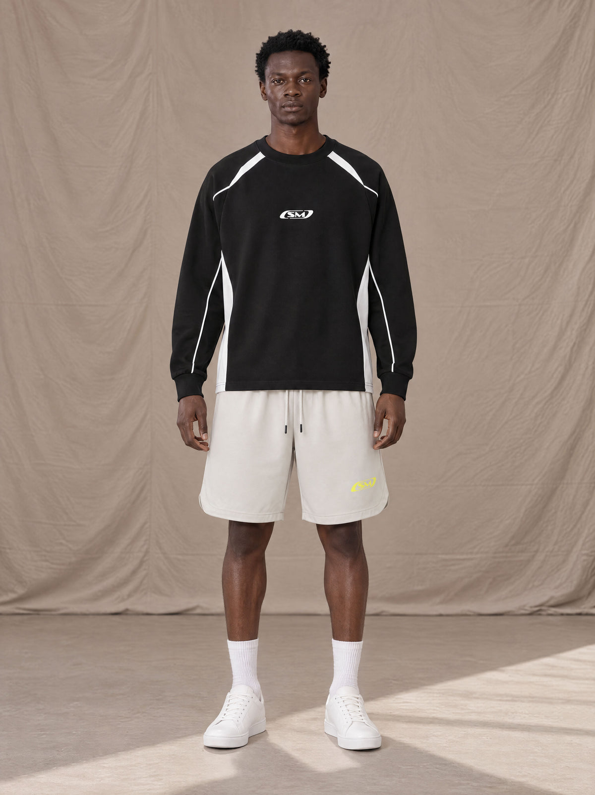 Model wearing SM Motion Sweatshirt in Midnight Black, front view.