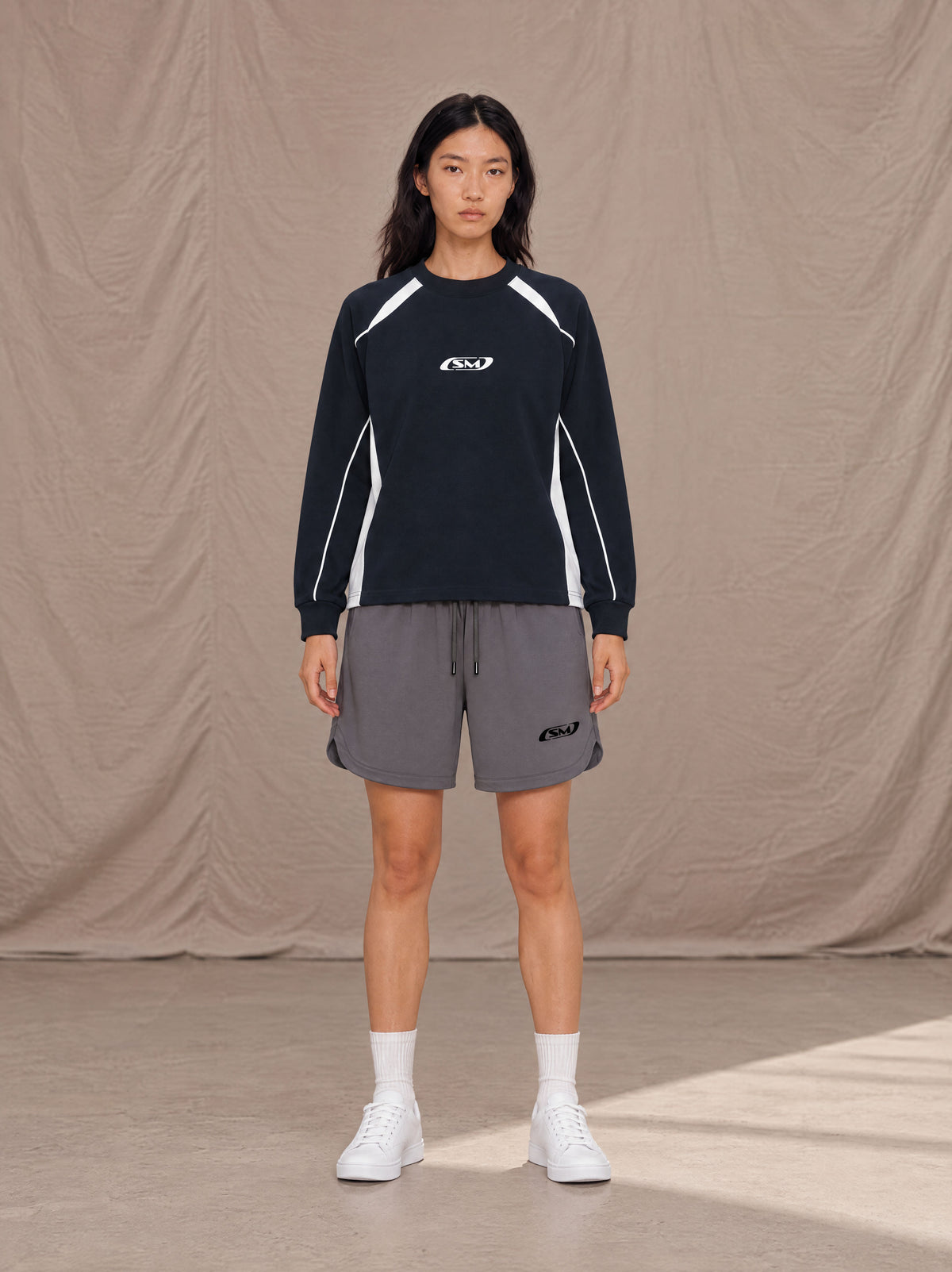 Model wearing SM Motion Sweatshirt in Oxford Navy, front view.