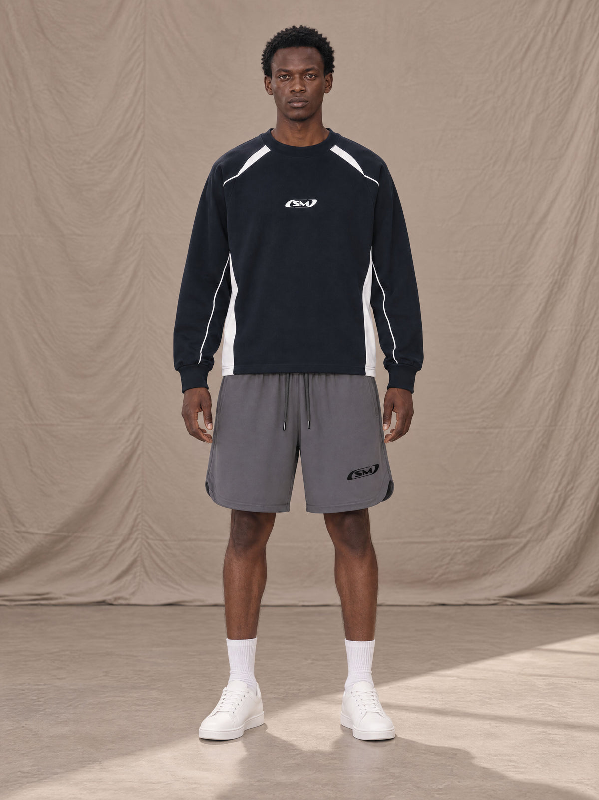 Model wearing SM Motion Sweatshirt in Oxford Navy, front view.