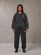 Model wearing the SM Sig. Boxy Hoodie with SM Sig. Jogger Sweatpants in Midnight Black, front view.