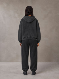 Model wearing the SM Sig. Boxy Hoodie with SM Sig. Jogger Sweatpants in Midnight Black, rear view.
