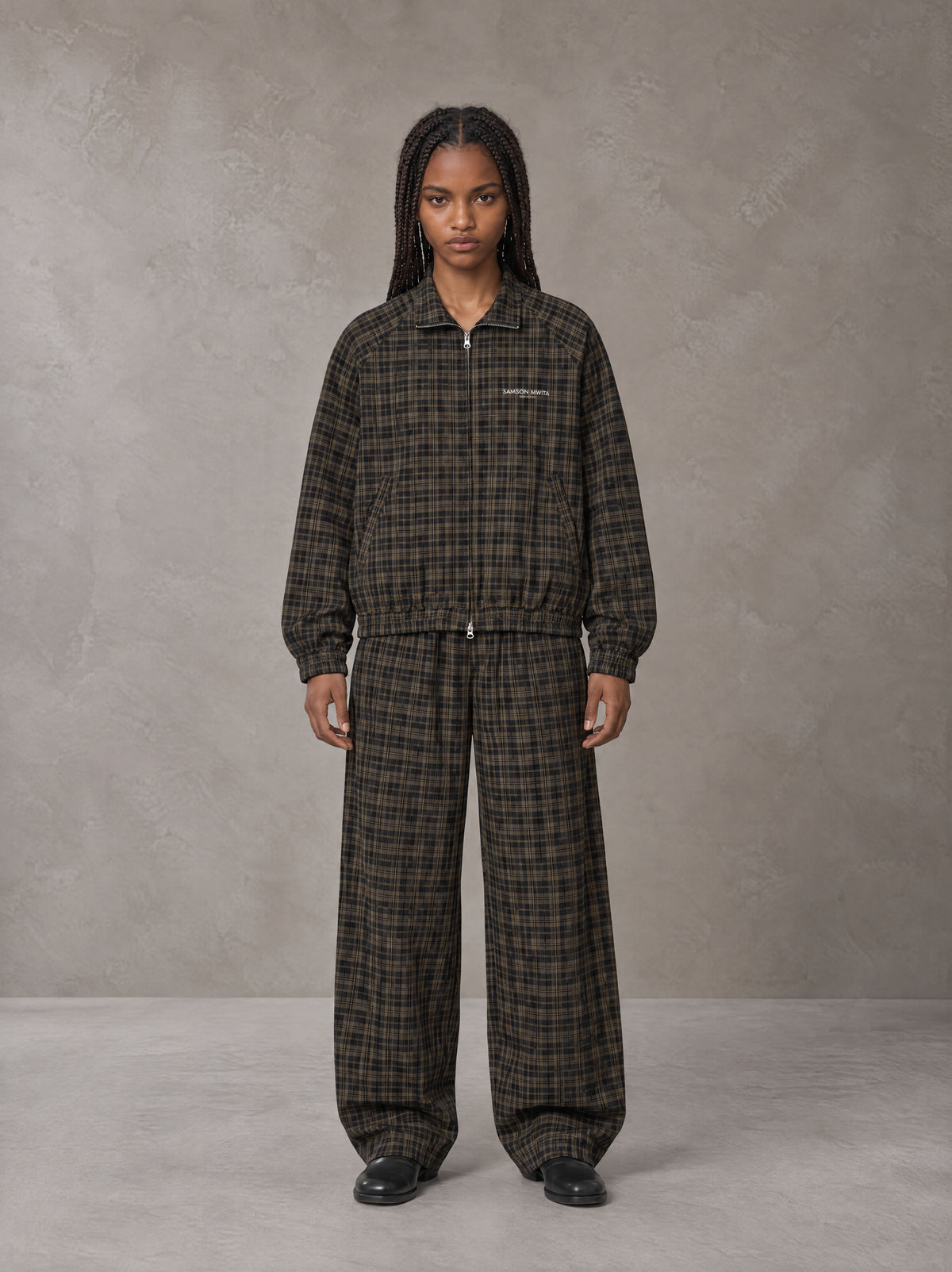 Model wearing the SM Meridian Jacket and SM Meridian Trousers in Loden, front view.