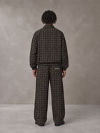 Model wearing the SM Meridian Jacket and SM Meridian Trousers in Loden, rear view.
