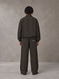 Model wearing the SM Meridian Jacket and SM Meridian Trousers in Loden, rear view.