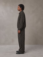 Model wearing the SM Meridian Jacket and SM Meridian Trousers in Loden, side profile.