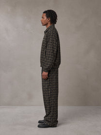 Model wearing the SM Meridian Jacket and SM Meridian Trousers in Loden, side profile.