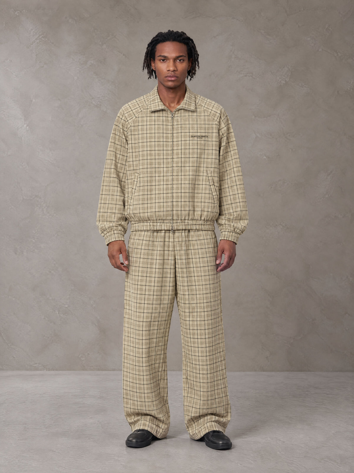 Model wearing the SM Meridian Jacket and SM Meridian Trousers in Ecru, front view.