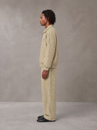 Model wearing the SM Meridian Jacket and SM Meridian Trousers in Ecru, side profile.