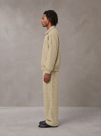 Model wearing the SM Meridian Jacket and SM Meridian Trousers in Ecru, side profile.