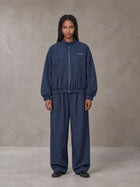 Model wearing the SM Axis Jacket and SM Axis Trousers in Oxford Navy, front view.