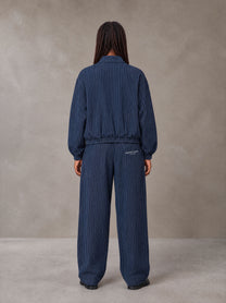 Model wearing the SM Axis Jacket and SM Axis Trousers in Oxford Navy, rear view.