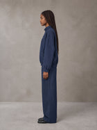 Model wearing the SM Axis Jacket and SM Axis Trousers in Oxford Navy, side profile.
