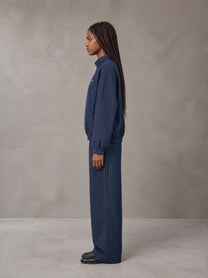 Model wearing the SM Axis Jacket and SM Axis Trousers in Oxford Navy, side profile.