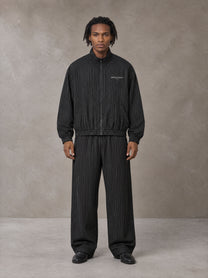 Model wearing the SM Axis Jacket and SM Axis Trousers in Midnight Black, front view.
