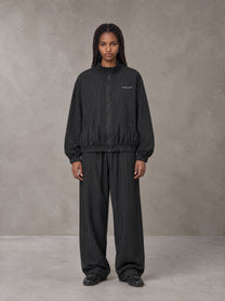 Model wearing the SM Axis Jacket and SM Axis Trousers in Midnight Black, front view.