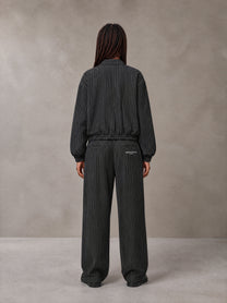 Model wearing the SM Axis Jacket and SM Axis Trousers in Midnight Black, rear view.