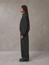 Model wearing the SM Axis Jacket and SM Axis Trousers in Midnight Black, side profile.