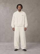 Model wearing the SM Axis Jacket and SM Axis Trousers in Oat Grey, front view.