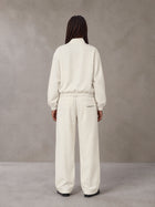 Model wearing the SM Axis Jacket and SM Axis Trousers in Oat Grey, rear view.