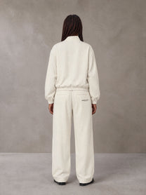 Model wearing the SM Axis Jacket and SM Axis Trousers in Oat Grey, rear view.