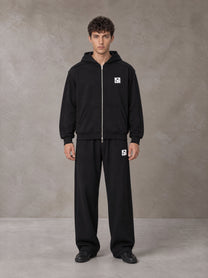 Model wearing the SM Contour Line Zip Hoodie and SM Contour Line Sweatpants in Midnight Black, front view.