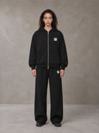 Model wearing the SM Contour Line Zip Hoodie and SM Contour Line Sweatpants in Midnight Black, front view.
