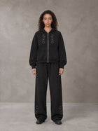 Model wearing the SM Shadow Pulse Hoodie and SM Shadow Pulse Sweatpants in Midnight Black, front view.