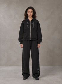 Model wearing the SM Shadow Pulse Hoodie and SM Shadow Pulse Sweatpants in Midnight Black, front view.