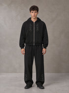 Model wearing the SM Shadow Pulse Hoodie and SM Shadow Pulse Sweatpants in Midnight Black, front view.