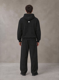 Model wearing the SM Shadow Pulse Hoodie and SM Shadow Pulse Sweatpants in Midnight Black, rear view.