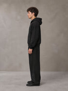 Model wearing the SM Shadow Pulse Hoodie and SM Shadow Pulse Sweatpants in Midnight Black, side profile.